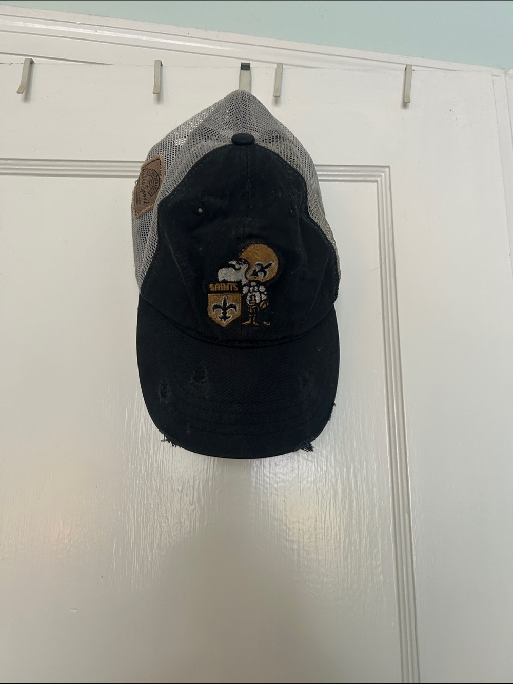 Retro Sports Saints Black and Gray Mesh Trucker Hat with Gold Logo Patch
